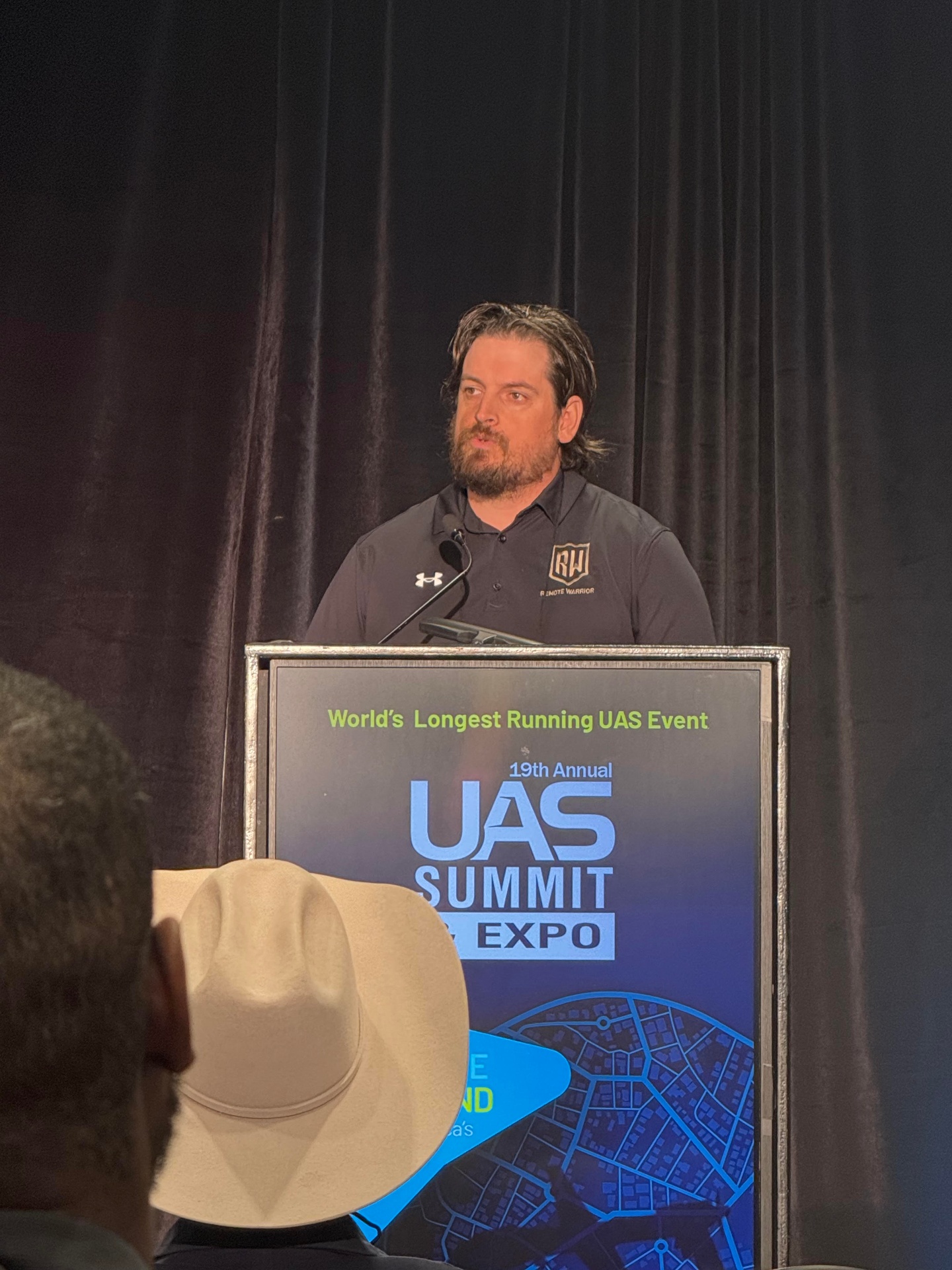 Tanner Yackley speaking from the podium at the 19th Annual UAS Summit & Expo.